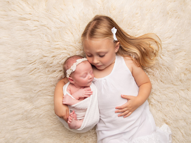 Newborn baby photo shoot with older child sibling in Sheffield, Yorkshire. 
